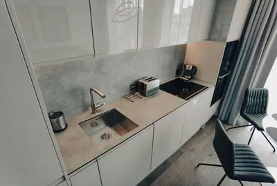 a kitchen with a sink and a microwave at Brand new apartment in Vilnius center. in Vilnius