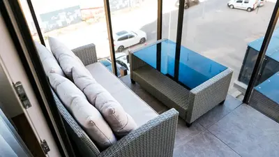 a room with two chairs and a glass table at Brand new apartment in Vilnius center. in Vilnius