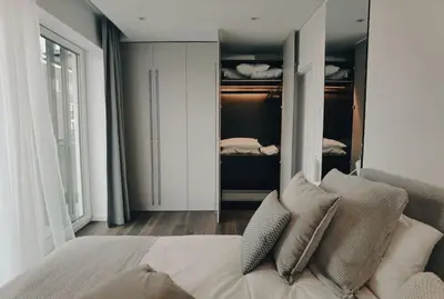 a bedroom with a bed and a walk in closet at Brand new apartment in Vilnius center. in Vilnius