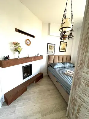a bedroom with a bed and a fireplace at Spectacular river view apartment in Vilnius