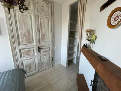 a room with a door and a table with flowers at Spectacular river view apartment in Vilnius