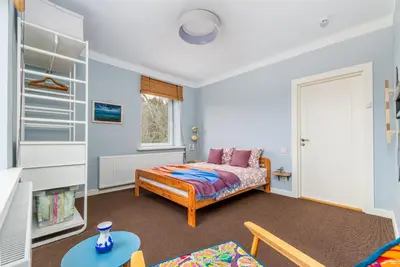 a bedroom with a bed and a table in a room at Art&Comfort Country in Kaunas