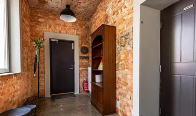a brick hallway with a door and a brick wall at Art&Comfort Country in Kaunas