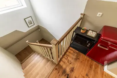 a staircase with a red refrigerator in a house at Art&Comfort Country in Kaunas