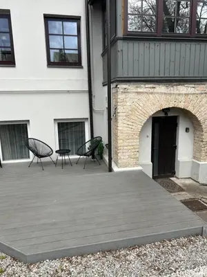 a patio with two chairs and a building at Stylish & Cozy Uzupis Apartment by URBAN RENT in Vilnius