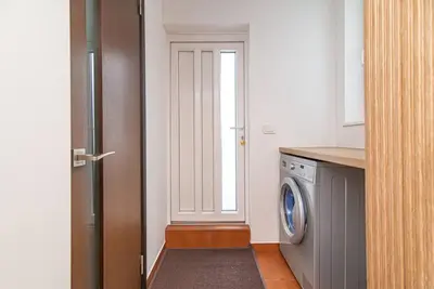 a kitchen with a washing machine and a window at Stylish & Cozy Uzupis Apartment by URBAN RENT in Vilnius