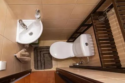a bathroom with a white sink and a staircase at Stylish & Cozy Uzupis Apartment by URBAN RENT in Vilnius