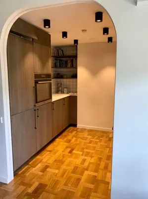 a kitchen with an archway leading to a kitchenasteryasteryasteryasteryasteryastery at New appartment with art collection in Vilnius
