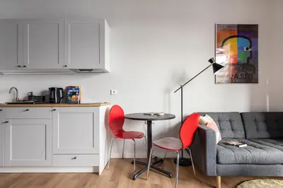 a living room with a couch and a table and chairs at #stayhere - Brand New Colourful Studio close to Shopping Malls in Vilnius