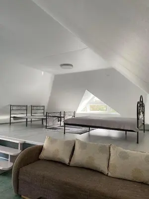 a living room with two beds and a couch at „Sėlių Studio“ Apartamentai in Utena