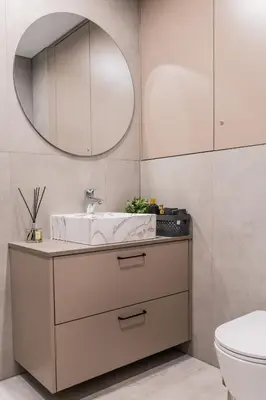 a bathroom with a sink and a mirror at Frida Elite Apartments in Šiauliai