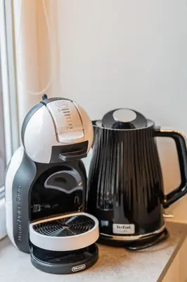 a coffee maker is sitting on a counter at Frida Elite Apartments in Šiauliai