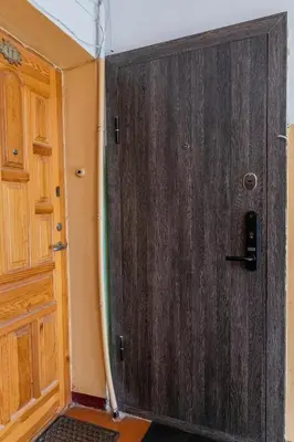 a wooden door in a room next to a door at Frida Elite Apartments in Šiauliai