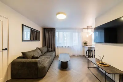 a living room with a couch and a table at Frida Elite Apartments in Šiauliai