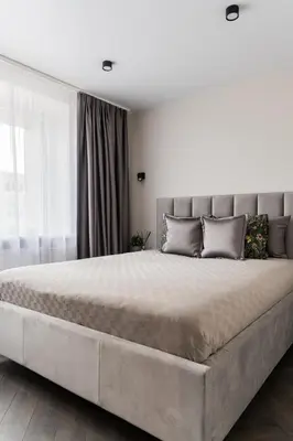 a large bed in a bedroom with a large bed sidx sidx sidx at Frida Elite Apartments in Šiauliai