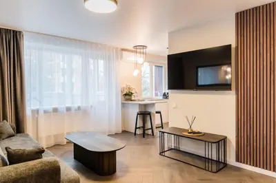 a living room with a couch and a table at Frida Elite Apartments in Šiauliai