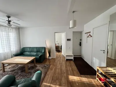 a living room with a green couch and a table at Holiday Ap in Visaginas