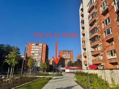 a street in a city with a sign that reads the flat here at Holiday Ap in Visaginas