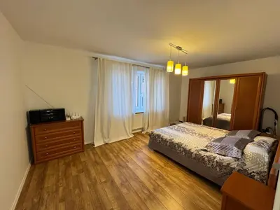 a bedroom with a bed and a dresser and a window at Holiday Ap in Visaginas