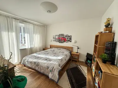 a bedroom with a bed and a large window at Holiday Ap in Visaginas