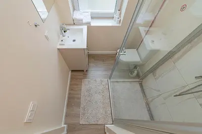 a bathroom with a shower and a glass door at Studio apartment Contrast By Polo Apartments in Kaunas
