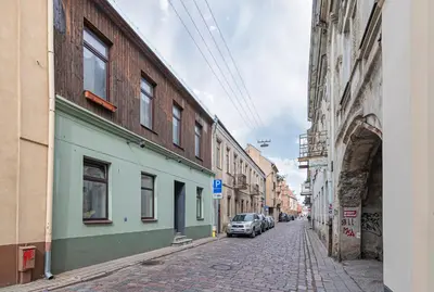 a street with buildings and a car parked on the street at Studio apartment Contrast By Polo Apartments in Kaunas