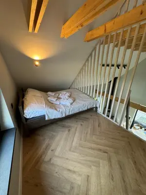 a bedroom with a bed and a staircase at Lavender Resort in Molėtai