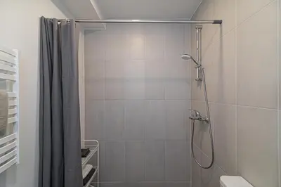 a bathroom with a shower with a shower curtain at G-47 Near the Parliament - Self check in in Vilnius