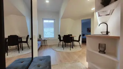 a kitchen and living room with a table and chairs at G-47 Near the Parliament - Self check in in Vilnius