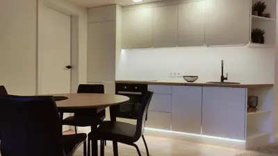 a kitchen with a table and chairs and cabinets at G-47 Near the Parliament - Self check in in Vilnius