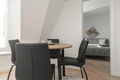 a dining room with a table and chairs and a bed at G-47 Near the Parliament - Self check in in Vilnius