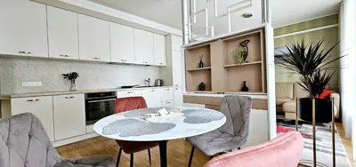 a kitchen with a table and chairs in a room at Aquapartment Druskininkai in Druskininkai