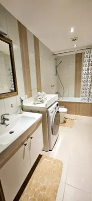 a bathroom with a washing machine and a sink at Aquapartment Druskininkai in Druskininkai
