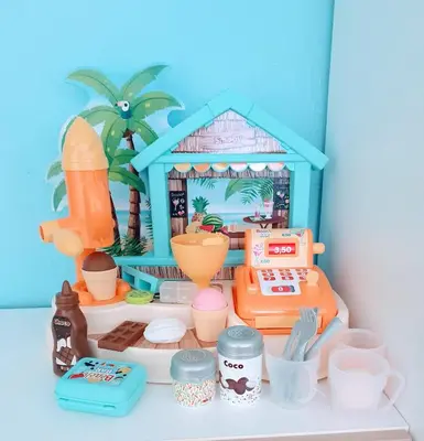 a toy kitchen with a table with food and utensils at SPACIOUS Apartment in the SUN CITY in Šiauliai