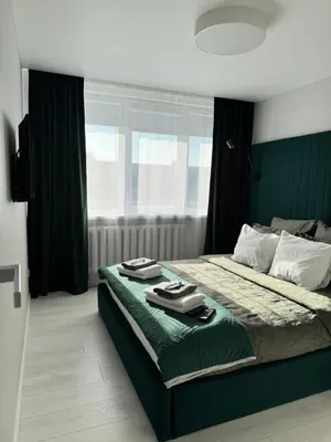 a bedroom with a bed with two plates on it at Apartments in Šiauliai city center in Šiauliai