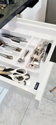a white drawer with scissors and other utensils on it at Apartments in Šiauliai city center in Šiauliai