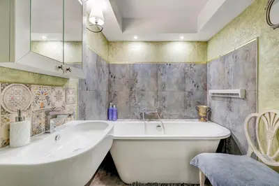 a bathroom with a large tub and a sink at LOCUSDO Apartment no. 137 near OZAS, AKROPOLIS in Vilnius