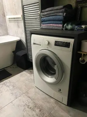 a washing machine in a bathroom next to a sink at LOCUSDO Apartment no. 137 near OZAS, AKROPOLIS in Vilnius