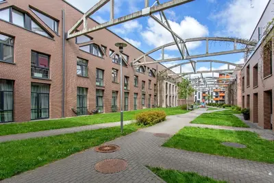 a walkway in front of a brick building at LOCUSDO Apartment no. 137 near OZAS, AKROPOLIS in Vilnius