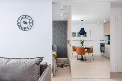 a kitchen and a living room with a dining room table at Near Gates of Dawn / Modern 1 bedroom / w/Netflix in Vilnius