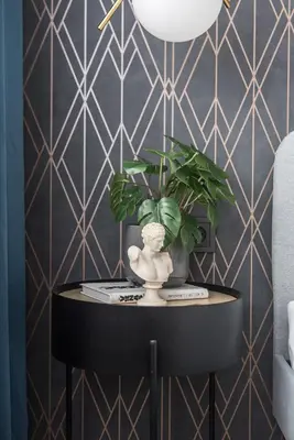 a table with a plant and a statue on it at Near Gates of Dawn / Modern 1 bedroom / w/Netflix in Vilnius