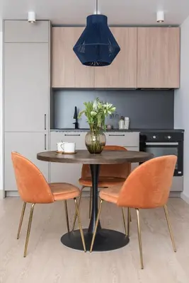 a dining room table with orange chairs and a vase with flowers at Near Gates of Dawn / Modern 1 bedroom / w/Netflix in Vilnius