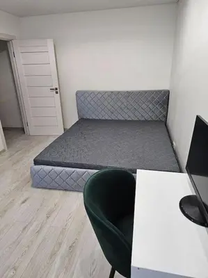 a bedroom with a bed and a chair and a desk at Gražus ir ramus butas jonavoje in Jonava