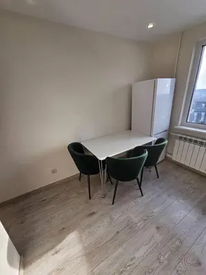 a kitchen with a table and chairs and a refrigerator at Gražus ir ramus butas jonavoje in Jonava