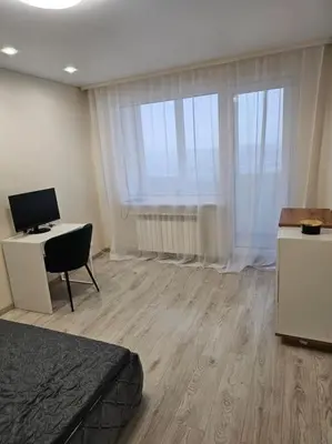 a room with a bed and a desk with a computer at Gražus ir ramus butas jonavoje in Jonava