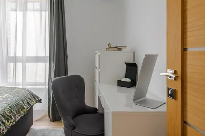 a bedroom with a desk with a chair and a bed at Fantasy House, cozzy apartmens, free parking, long stays welcome in Vilnius