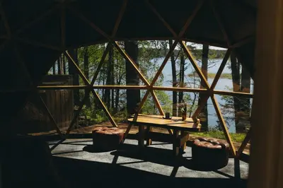 a room with a wooden table in a yurt at Asalnai Campsite in Ignalina