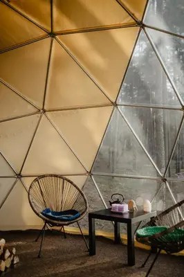 a room with a chair and a table in a igloo at Asalnai Campsite in Ignalina