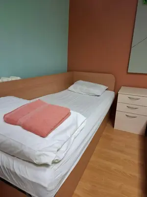 a bedroom with a bed with a red towel on it at Jamaika @ Shopen in Vilnius