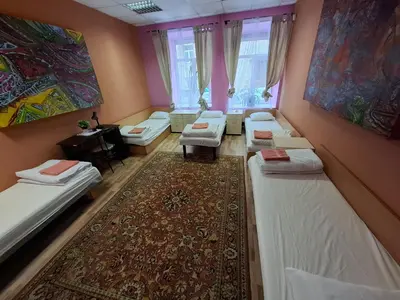 a room with a bunch of beds and a rug at Jamaika @ Shopen in Vilnius